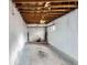 Spacious garage with exposed ceiling and white door, ready for customization at 1645 Tamarac St, Denver, CO 80220