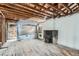 Spacious living room featuring wood floors and a brick fireplace at 1645 Tamarac St, Denver, CO 80220