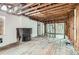 Living room showing hardwood floors and exposed wall studs at 1645 Tamarac St, Denver, CO 80220