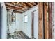 Unfinished room showing a water heater and a doorway at 1645 Tamarac St, Denver, CO 80220