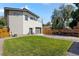 Spacious backyard with a lush lawn, modern garage, and privacy fence, perfect for outdoor activities and relaxation at 4312 Xavier St, Denver, CO 80212