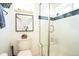 Clean bathroom with a toilet, a framed animal print, and a glass shower with modern black and white tile at 4312 Xavier St, Denver, CO 80212