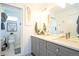 Well-lit bathroom featuring a double sink vanity, modern fixtures, and access to the commode at 4312 Xavier St, Denver, CO 80212