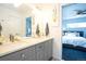 Stylish bathroom with a double sink vanity, modern fixtures, and a view to the adjoining bedroom at 4312 Xavier St, Denver, CO 80212