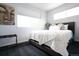 Bright bedroom featuring a comfortable bed and a modern decor with art, and a large window at 4312 Xavier St, Denver, CO 80212