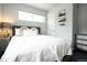 Cozy bedroom with a modern decor, plush bedding, and lots of natural light from the horizontal window at 4312 Xavier St, Denver, CO 80212