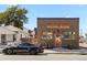 Unique building with a dark exterior, wooden details, and a cool bar sign. A Porsche is parked out front at 4312 Xavier St, Denver, CO 80212
