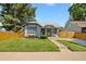 Charming single-story home with a well-manicured lawn and cozy front porch, framed by mature trees at 4312 Xavier St, Denver, CO 80212