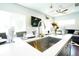 Kitchen island with granite counters, stainless steel sink, and a breakfast bar at 4312 Xavier St, Denver, CO 80212