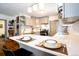 Eat in kitchen featuring white countertops, stainless steel appliances and ample cabinet space at 4312 Xavier St, Denver, CO 80212