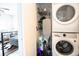 Efficient laundry area with stacked washer and dryer, and practical storage shelving at 4312 Xavier St, Denver, CO 80212