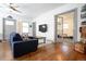 Living room featuring hardwood floors, gray trim, and french doors at 4312 Xavier St, Denver, CO 80212