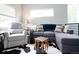 Cozy living room with a sectional sofa and stylish cowhide rug at 4312 Xavier St, Denver, CO 80212