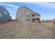 View of the home from the backyard, highlighting the deck, exterior finishes, and surrounding landscape at 1202 Lance Leaf Ct, Elizabeth, CO 80107