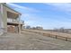 Exterior view showing the house from the backyard, featuring a covered deck and views of the community at 1202 Lance Leaf Ct, Elizabeth, CO 80107