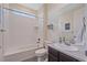Well-lit bathroom with tiled shower/tub combo, modern sink, and neutral decor at 1202 Lance Leaf Ct, Elizabeth, CO 80107
