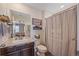 Bathroom with white walls, wood cabinets and shower/tub combo at 1202 Lance Leaf Ct, Elizabeth, CO 80107