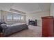 Bright bedroom with large windows, tray ceiling and plush carpet at 1202 Lance Leaf Ct, Elizabeth, CO 80107