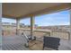 Relaxing covered deck with scenic views, complete with rocking chairs and outdoor seating at 1202 Lance Leaf Ct, Elizabeth, CO 80107