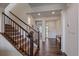 Bright foyer featuring hardwood floors, a staircase with wood banister, and a coat closet at 1202 Lance Leaf Ct, Elizabeth, CO 80107