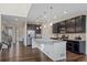 Modern kitchen featuring stainless steel appliances, a large island, and granite countertops at 1202 Lance Leaf Ct, Elizabeth, CO 80107
