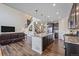 Open concept kitchen with stainless steel appliances, granite counters, and an island overlooking living room at 1202 Lance Leaf Ct, Elizabeth, CO 80107