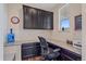 Functional office space with built-in cabinets, a granite countertop desk, and a window at 1202 Lance Leaf Ct, Elizabeth, CO 80107