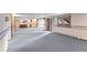 Finished basement with kitchenette, sliding door access to the exterior and neutral carpeting at 11686 W 74Th Way, Arvada, CO 80005