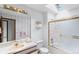 Bright bathroom showcasing a shower/tub combo, large vanity, and sky light at 11686 W 74Th Way, Arvada, CO 80005