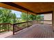 Wooden deck with views of surrounding trees, offering an open-air experience at 11686 W 74Th Way, Arvada, CO 80005