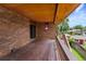Spacious wooden deck with brick siding and a view of the backyard, perfect for outdoor entertaining and relaxation at 11686 W 74Th Way, Arvada, CO 80005
