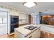 Functional kitchen with island cooktop, laminate floors and updated appliances at 11686 W 74Th Way, Arvada, CO 80005