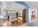 Spacious kitchen with laminate floors, island cooktop, and direct access to the living area at 11686 W 74Th Way, Arvada, CO 80005