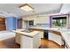 Functional kitchen with island cooktop, laminate floors and updated appliances at 11686 W 74Th Way, Arvada, CO 80005