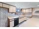 Basement kitchenette with stainless steel sink, black dishwasher, and neutral colored cabinets at 11686 W 74Th Way, Arvada, CO 80005