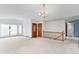 Open-concept living area with chandelier and staircase at 11686 W 74Th Way, Arvada, CO 80005