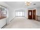 Bright living room featuring white carpet and large windows at 11686 W 74Th Way, Arvada, CO 80005