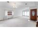 Bright living room featuring white carpet, chandelier, and large windows at 11686 W 74Th Way, Arvada, CO 80005
