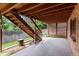 Open patio area with an upper wooden deck and adjacent landscaped backyard at 11686 W 74Th Way, Arvada, CO 80005