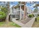 Charming townhome with gray siding, a brick chimney, and a cozy front porch at 6545 W 84Th Way # 132, Arvada, CO 80003
