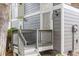Close up of the front porch with gray siding and a white security door at 6545 W 84Th Way # 132, Arvada, CO 80003