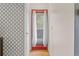 Hallway with a patterned wall, a door with a window, and light hardwood floors at 6545 W 84Th Way # 132, Arvada, CO 80003