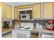 Kitchen with granite countertops, and appliances including a microwave and stove at 6545 W 84Th Way # 132, Arvada, CO 80003