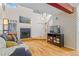 Open living room with hardwood floors and a fireplace next to a staircase at 6545 W 84Th Way # 132, Arvada, CO 80003