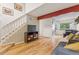 Inviting living room featuring hardwood floors, modern furniture, and stairs leading to the upper level at 6545 W 84Th Way # 132, Arvada, CO 80003