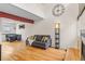 Bright living room featuring hardwood floors, a fireplace, and a large window at 6545 W 84Th Way # 132, Arvada, CO 80003