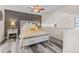 Comfortable main bedroom boasts a ceiling fan, modern lighting, a decorative wall, and a bed with storage at 6545 W 84Th Way # 132, Arvada, CO 80003