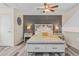 Comfortable main bedroom boasts a ceiling fan, modern lighting, a decorative wall, and a bed with storage at 6545 W 84Th Way # 132, Arvada, CO 80003
