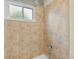 Shower features natural stone tiling, a rainfall shower head, and a frosted window at 6545 W 84Th Way # 132, Arvada, CO 80003