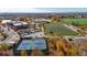 An aerial view of community recreation center with tennis courts, skate park, football field, and parking at 4311 Del Rio Ct, Denver, CO 80239